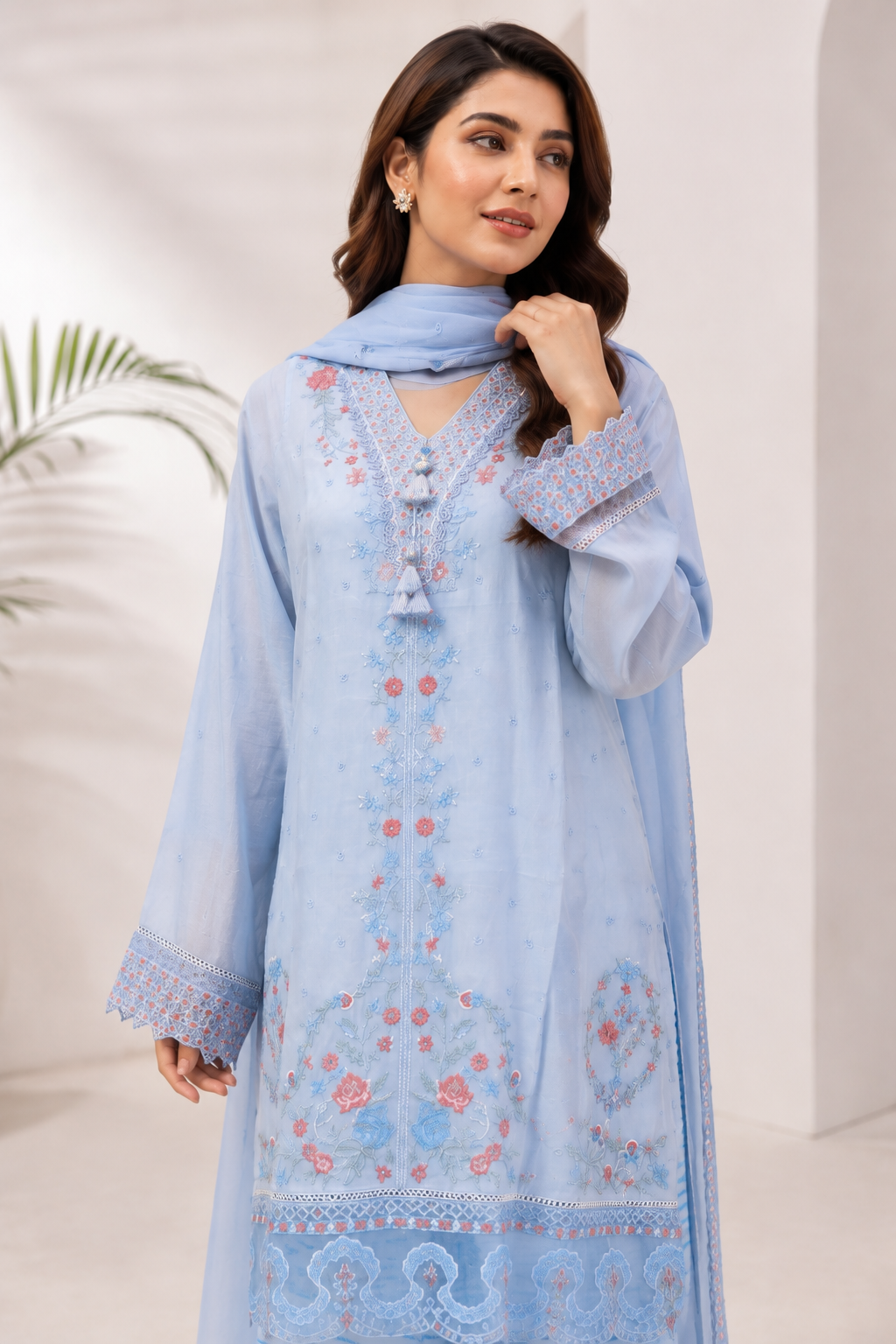 Model wearing a luxury sky blue embroidered ready-to-wear eastern dress with a tassel neckline, matching printed trousers, and an embroidered dupatta. libas e hayya | libas e haya
